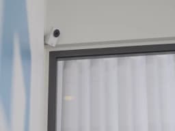 AXIS M1055-L from AXIS COMMUNICATIONS - Box Camera, mounted in a corner